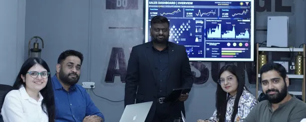 The InventivAI team around a sales dashboard