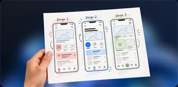 A hand holding printed wireframes of three app screen designs
