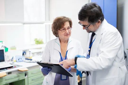 Two doctors going through a patient's chart in a clinic