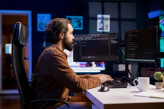 A researcher working through data on several screens