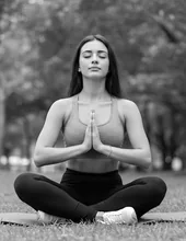 Woman meditating in a park