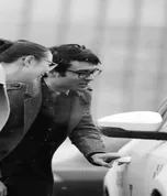 Couple inspecting a car with a dealer