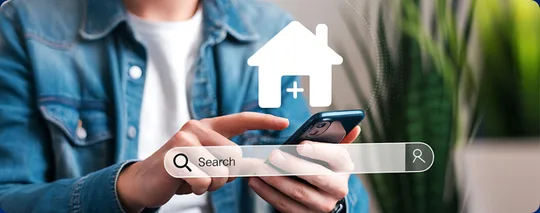 A hand searching for a home on a phone